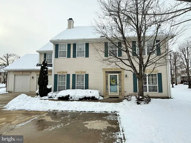 a view of a house with a yard covered in snow