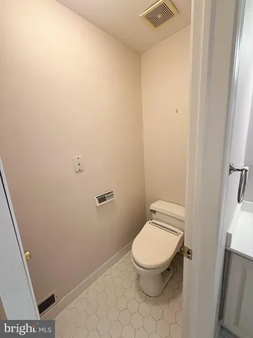 a white toilet sitting next to a shower