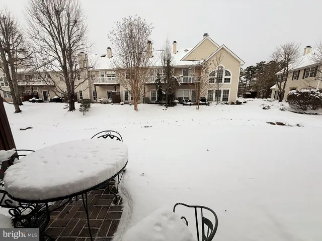 a view of a house with a snow in the yard