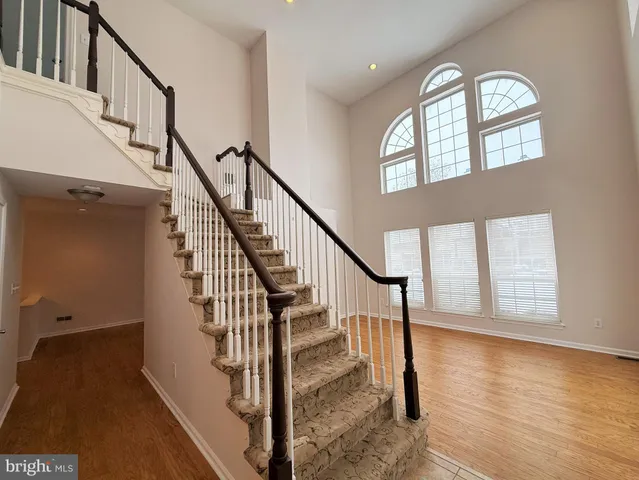 a view of an entryway with wooden floor and stairs