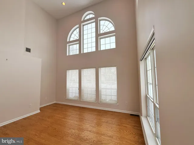 an empty room with windows mirror and windows