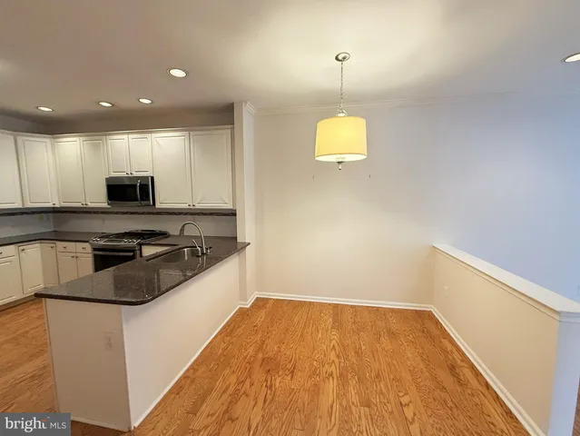 a kitchen with granite countertop a stove and a sink