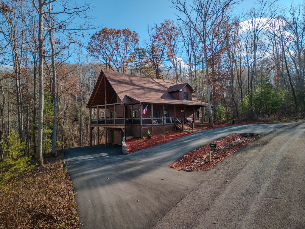 135 Grayson Point Blue Ridge, GA 30513 - Photo 37 of 46 a view of street with large trees and a wooden fence