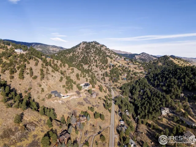 a view of a large mountain with mountains in the background