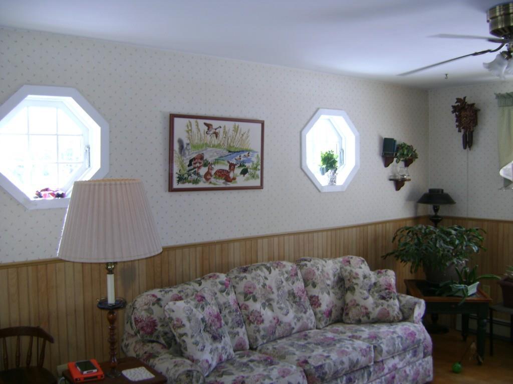 254 Blueberry Road Waterboro, ME 04087 - Photo 3 of 15 The sunlit living room has two...