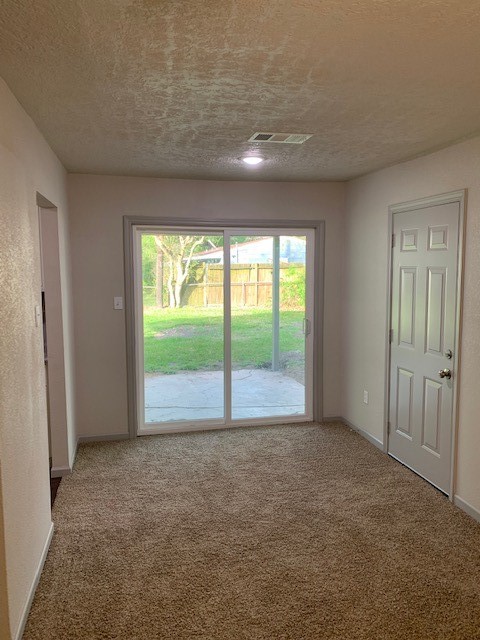 5244 Enyart Street Houston, TX 77021 - Photo 5 of 12 a view of an empty room with wooden floor and windows