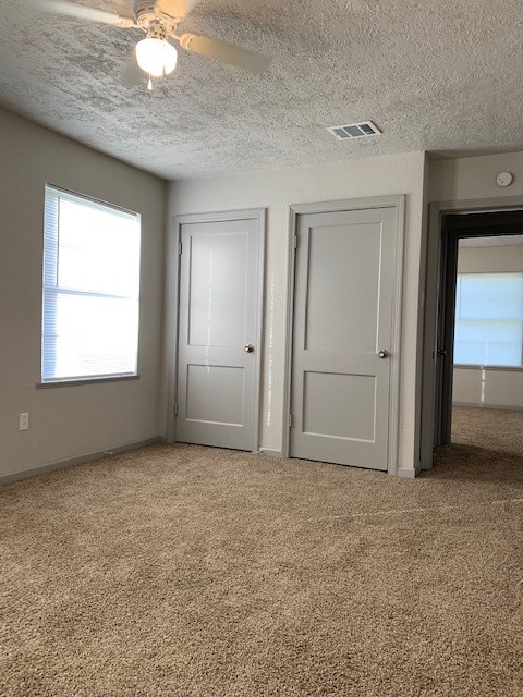 5244 Enyart Street Houston, TX 77021 - Photo 8 of 12 an empty room with windows and closet