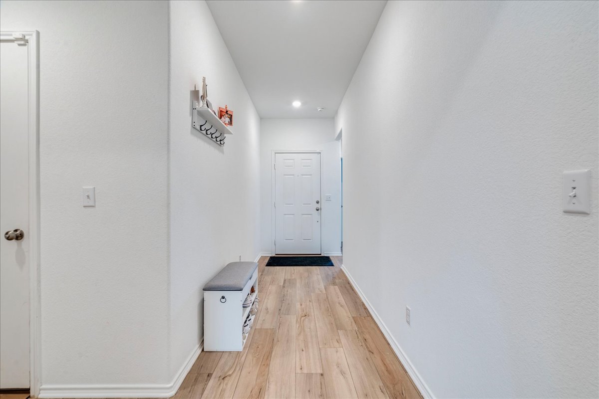 389 Salt Springs Road Kyle, TX 78640 - Photo 7 of 30 A welcoming entry hall with durable flooring and modern recessed lighting.