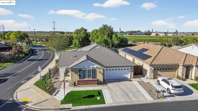 an aerial view of a house with a garden and lake view