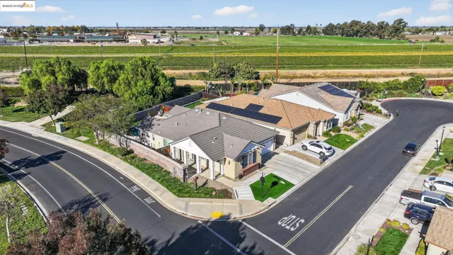 a front view of a house with a yard and potted plants