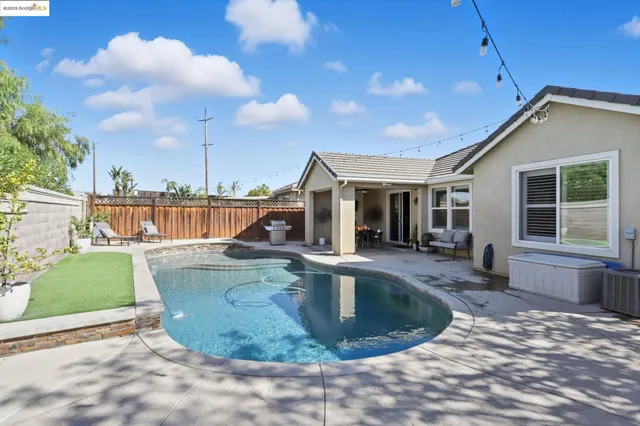 a living room with furniture and large windows