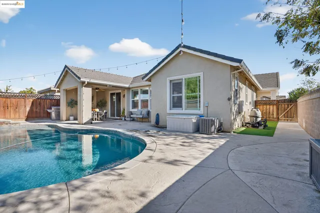 a large kitchen with granite countertop a sink and a white wooden cabinets