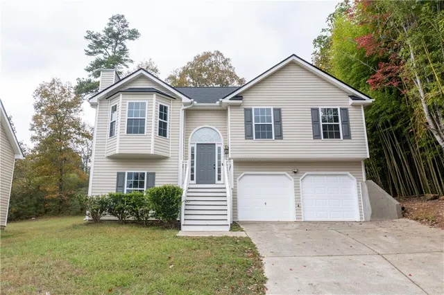 a front view of a house with a yard and garage