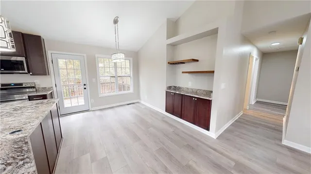 a view of a kitchen cabinets and wooden floor