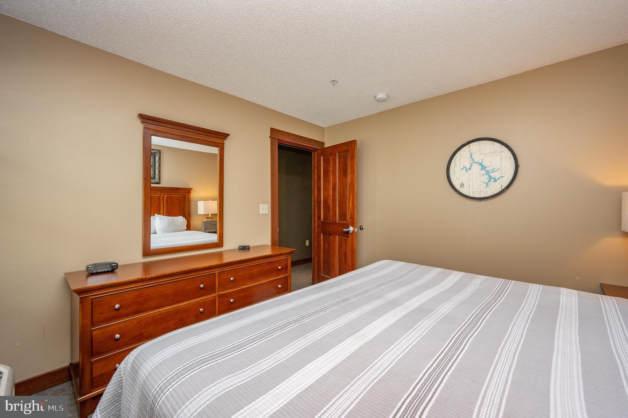 565 Glendale Road, Unit 103B Oakland, MD 21550 - Photo 6 of 53 a bedroom with a bed and a mirror