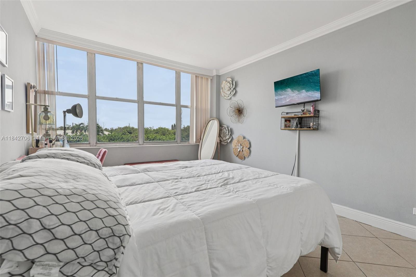 7441 Wayne Avenue, Unit 2B Miami Beach, FL 33141 - Photo 17 of 30 a bedroom with a bed and a large window