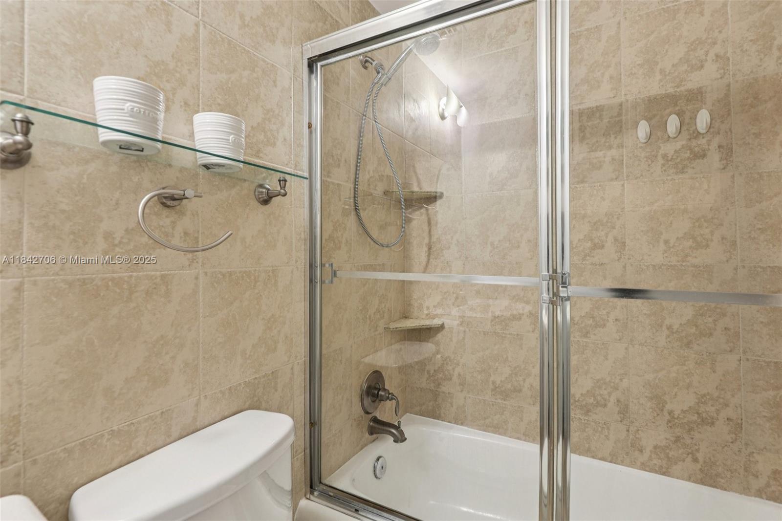 7441 Wayne Avenue, Unit 2B Miami Beach, FL 33141 - Photo 20 of 30 a bathroom with a shower and a toilet