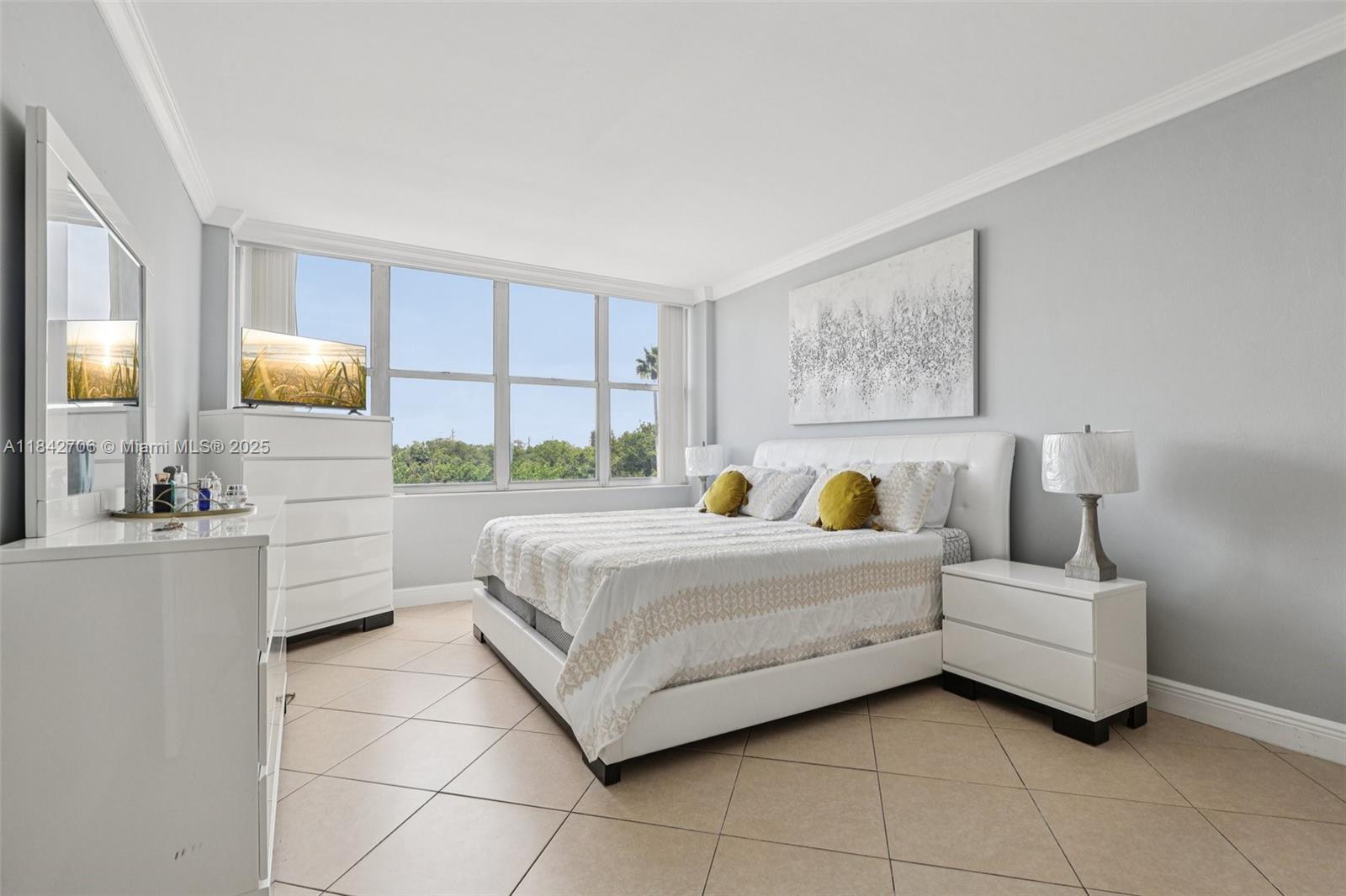 7441 Wayne Avenue, Unit 2B Miami Beach, FL 33141 - Photo 21 of 30 a bedroom with a bed couch and window