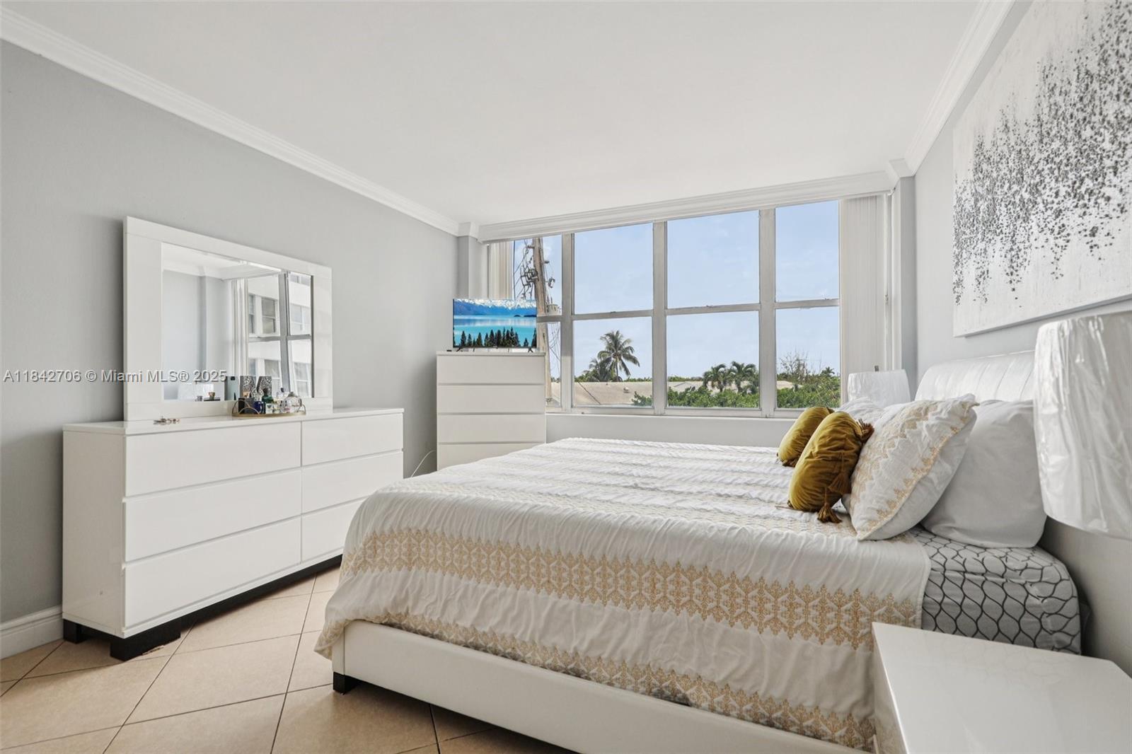 7441 Wayne Avenue, Unit 2B Miami Beach, FL 33141 - Photo 22 of 30 a bedroom with a large bed and a window