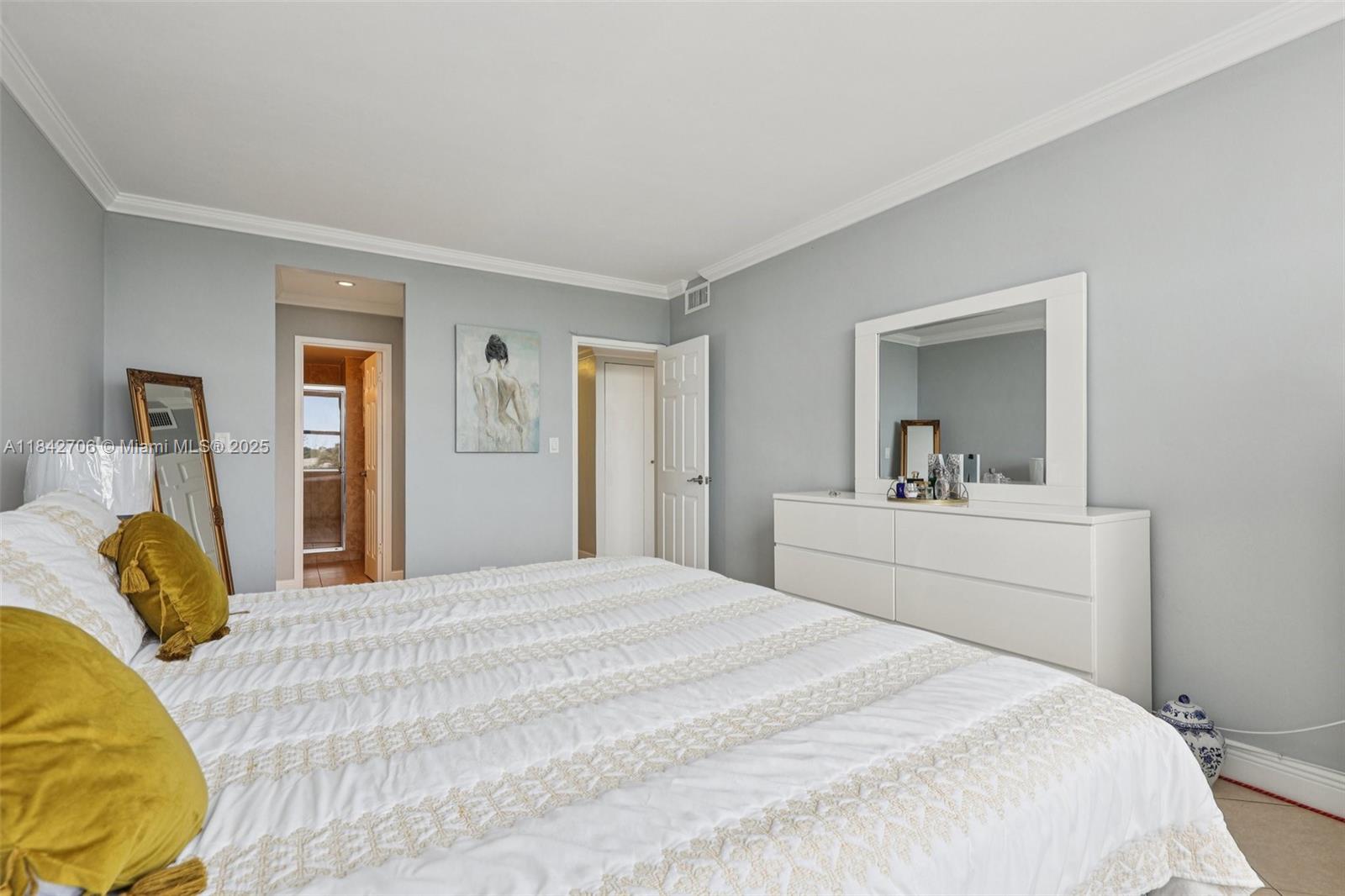 7441 Wayne Avenue, Unit 2B Miami Beach, FL 33141 - Photo 23 of 30 a bedroom with a bed and a mirror