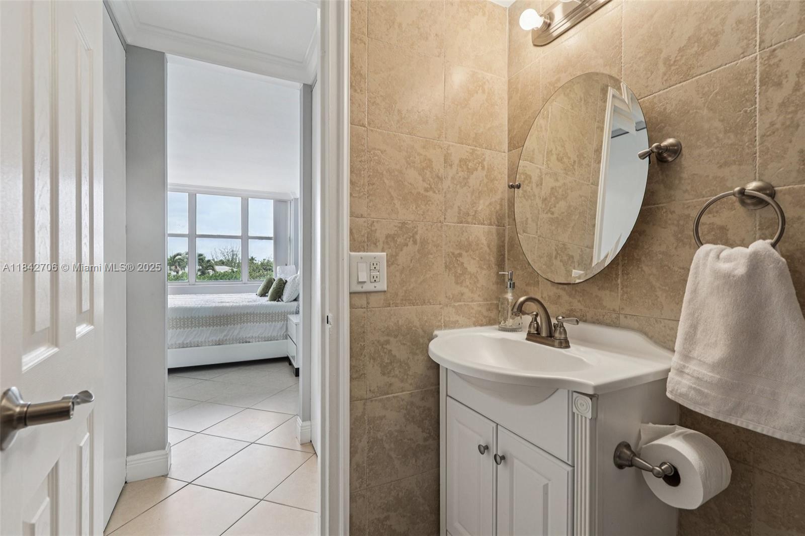 7441 Wayne Avenue, Unit 2B Miami Beach, FL 33141 - Photo 25 of 30 a bathroom with a sink a toilet and shower