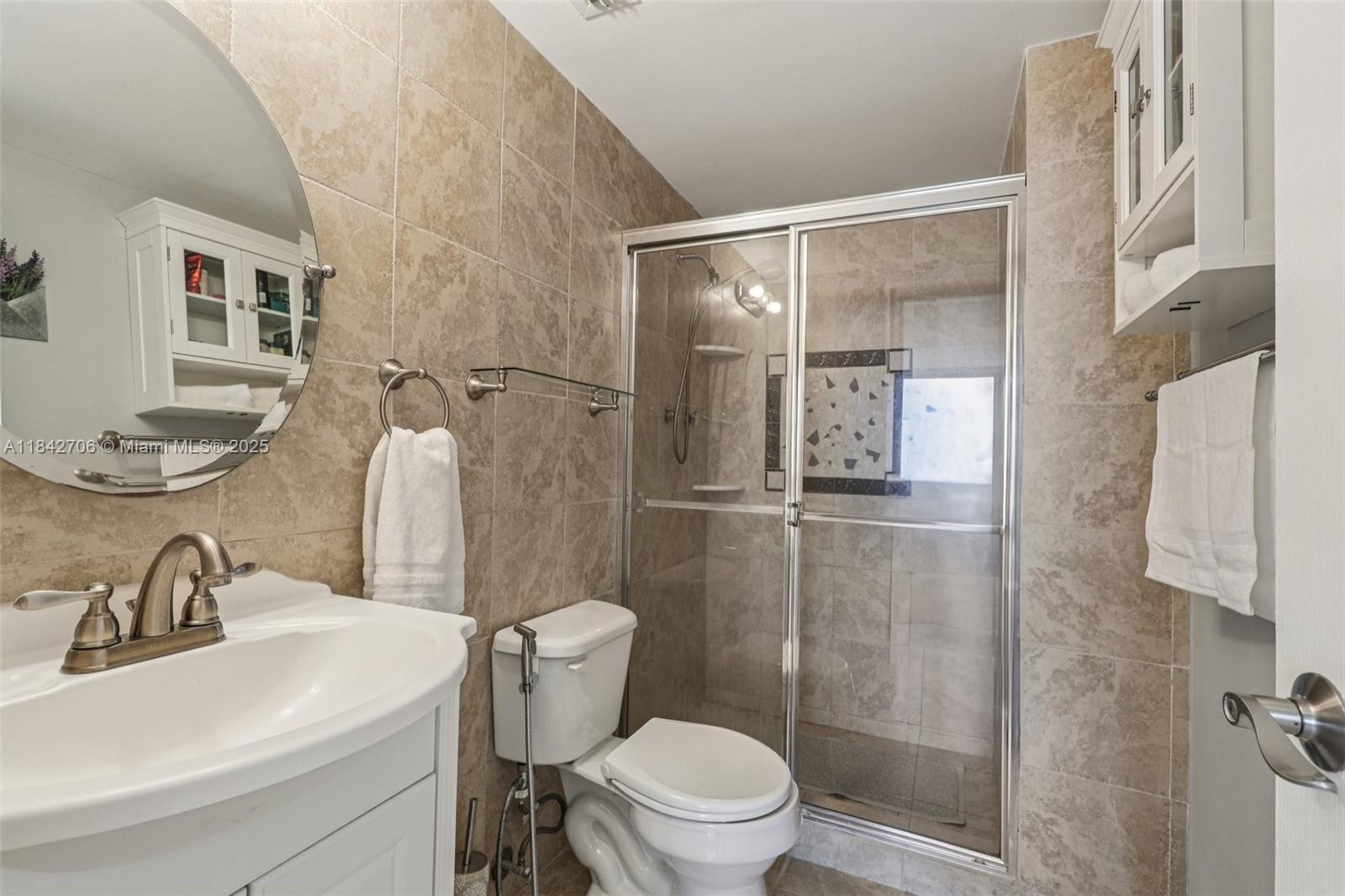 7441 Wayne Avenue, Unit 2B Miami Beach, FL 33141 - Photo 26 of 30 a bathroom with a sink toilet and shower