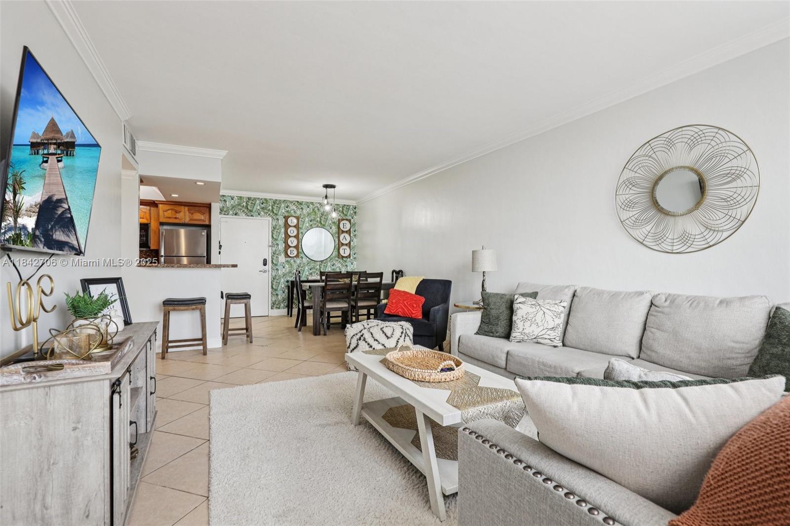 7441 Wayne Avenue, Unit 2B Miami Beach, FL 33141 - Photo 4 of 30 a living room with furniture and a flat screen tv