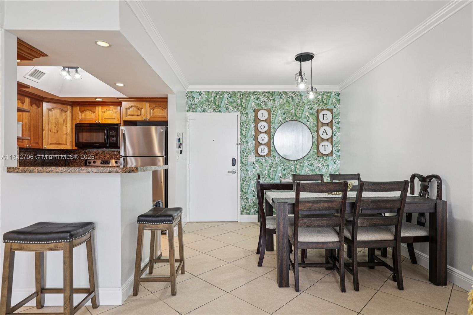 7441 Wayne Avenue, Unit 2B Miami Beach, FL 33141 - Photo 6 of 30 a dining room with furniture and window