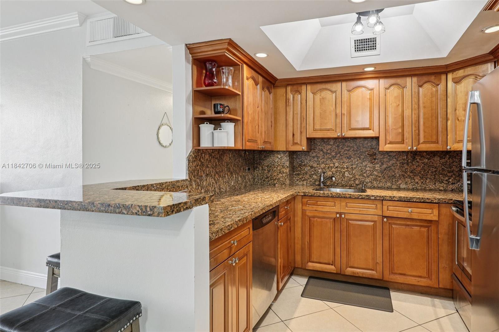 7441 Wayne Avenue, Unit 2B Miami Beach, FL 33141 - Photo 10 of 30 a kitchen with stainless steel appliances granite countertop a sink and cabinets