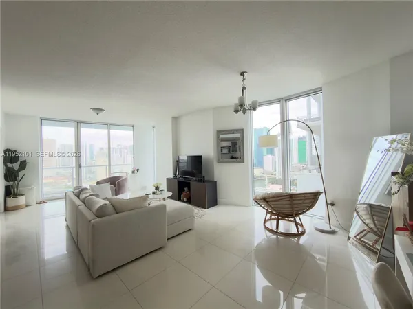 a living room with furniture and a large window