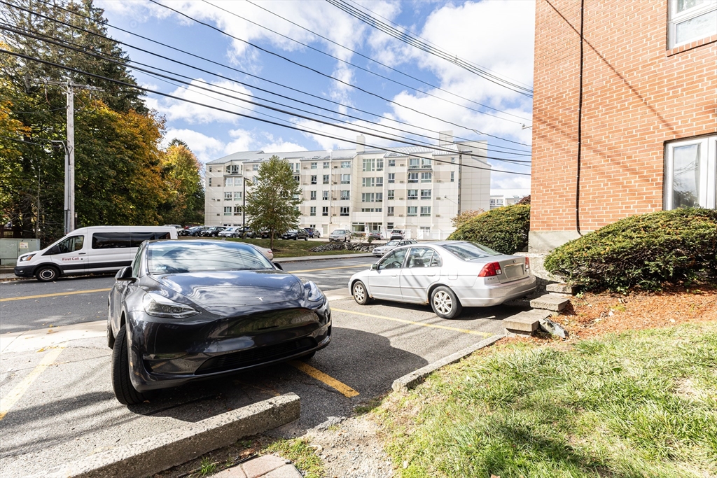 186 Lexington Street, Unit 8 Watertown, MA 02472 - Photo 17 of 22 a view of a cars park in front of house