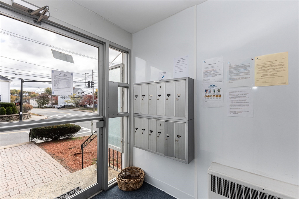 186 Lexington Street, Unit 8 Watertown, MA 02472 - Photo 19 of 22 a kitchen with stainless steel appliances kitchen island granite countertop a refrigerator and a stove