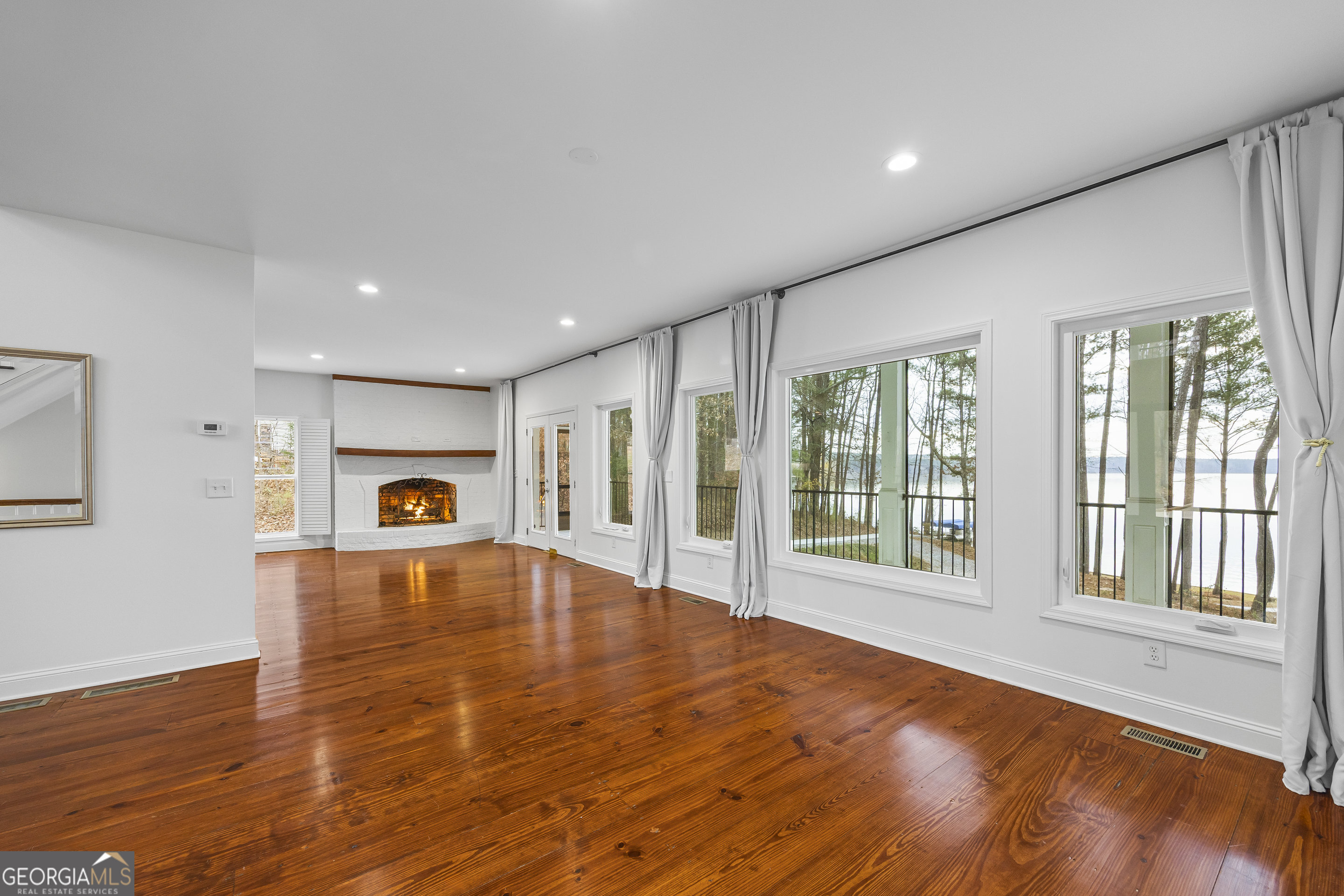 1270 Swords Road Greensboro, GA 30642 - Photo 14 of 44 a big room with wooden floor and a window