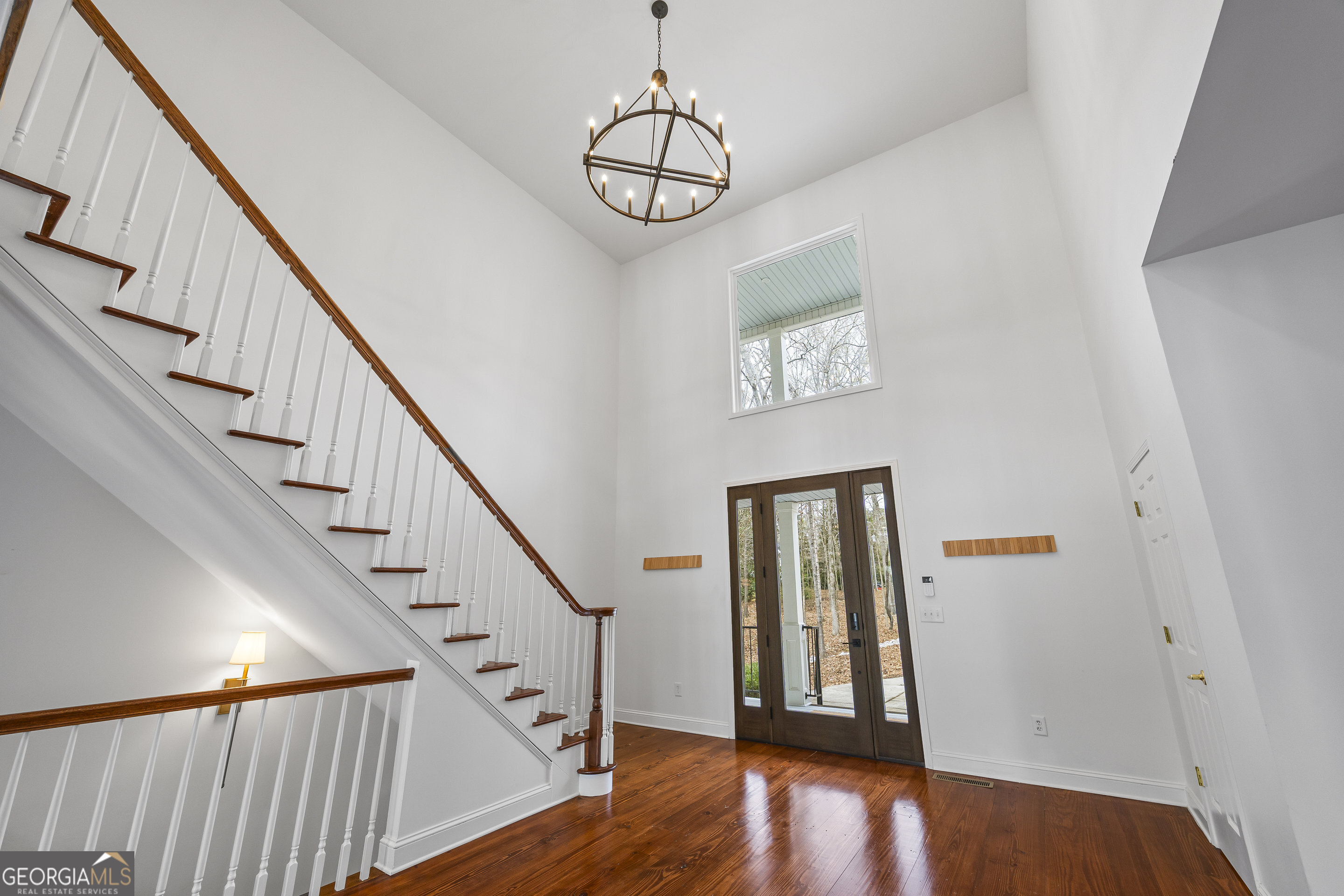 1270 Swords Road Greensboro, GA 30642 - Photo 8 of 44 a view of staircase with wooden floor and a chandelier