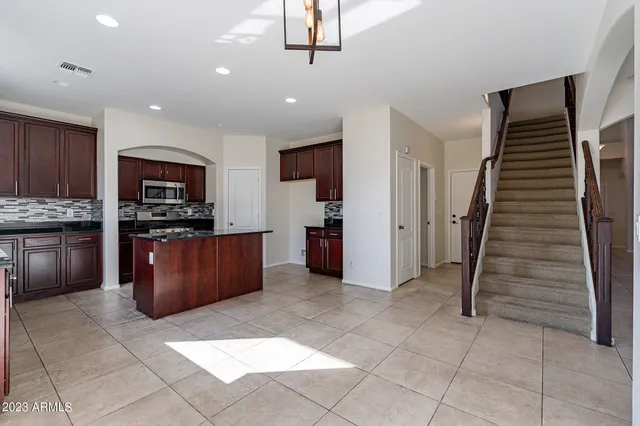 a kitchen with stainless steel appliances granite countertop a stove microwave and cabinets