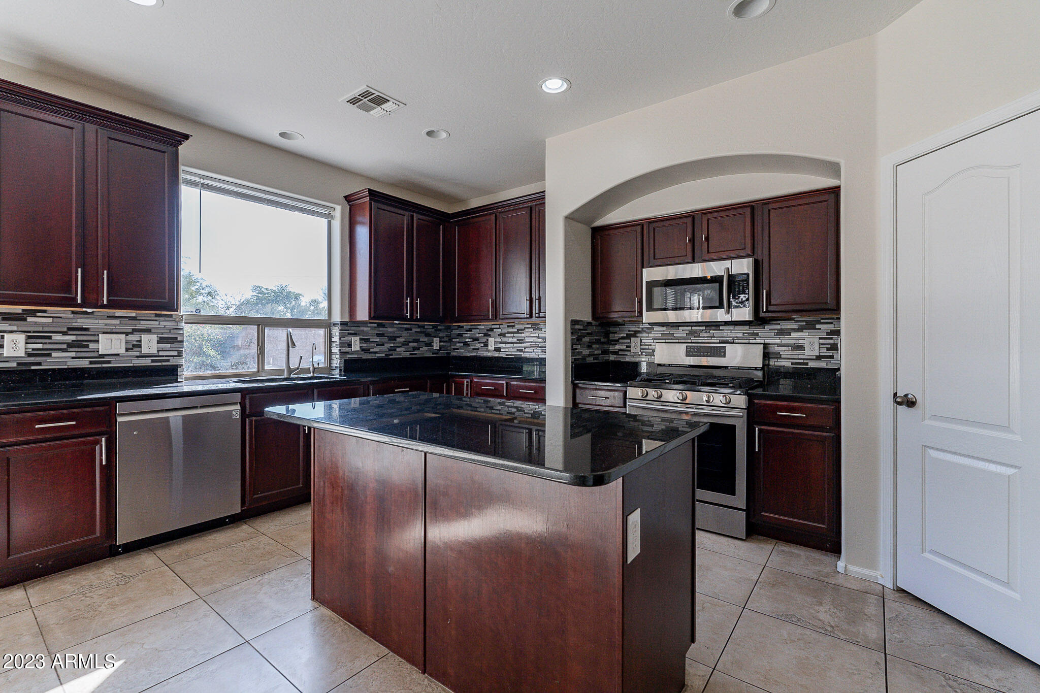 2943 East Quiet Hollow Lane Phoenix, AZ 85024 - Photo 15 of 65 a kitchen with granite countertop stainless steel appliances and cabinets