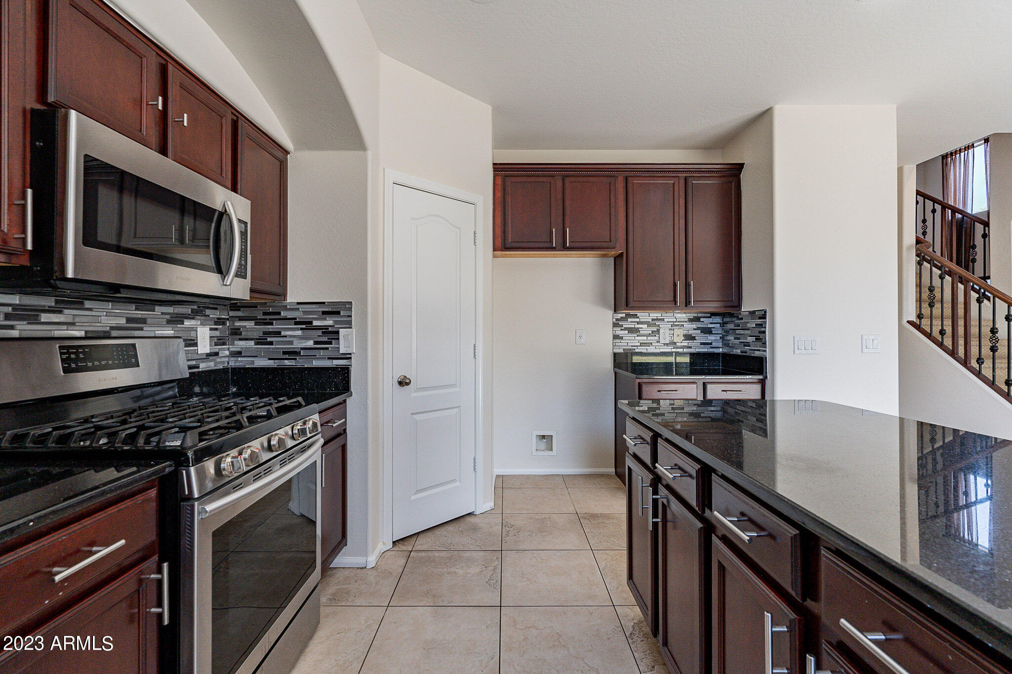 2943 East Quiet Hollow Lane Phoenix, AZ 85024 - Photo 18 of 65 a kitchen with kitchen island stainless steel appliances a stove a sink and a microwave