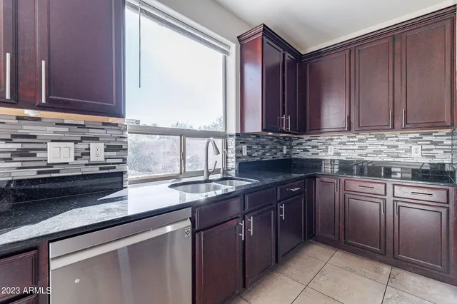 an empty room with closet and chandelier fan