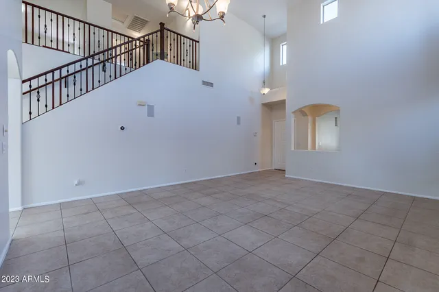 a view of a livingroom with furniture and chandelier fan