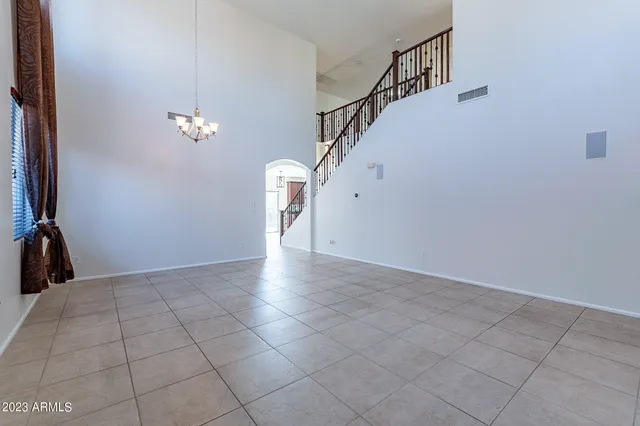 a view of main area with chandelier fan and windows