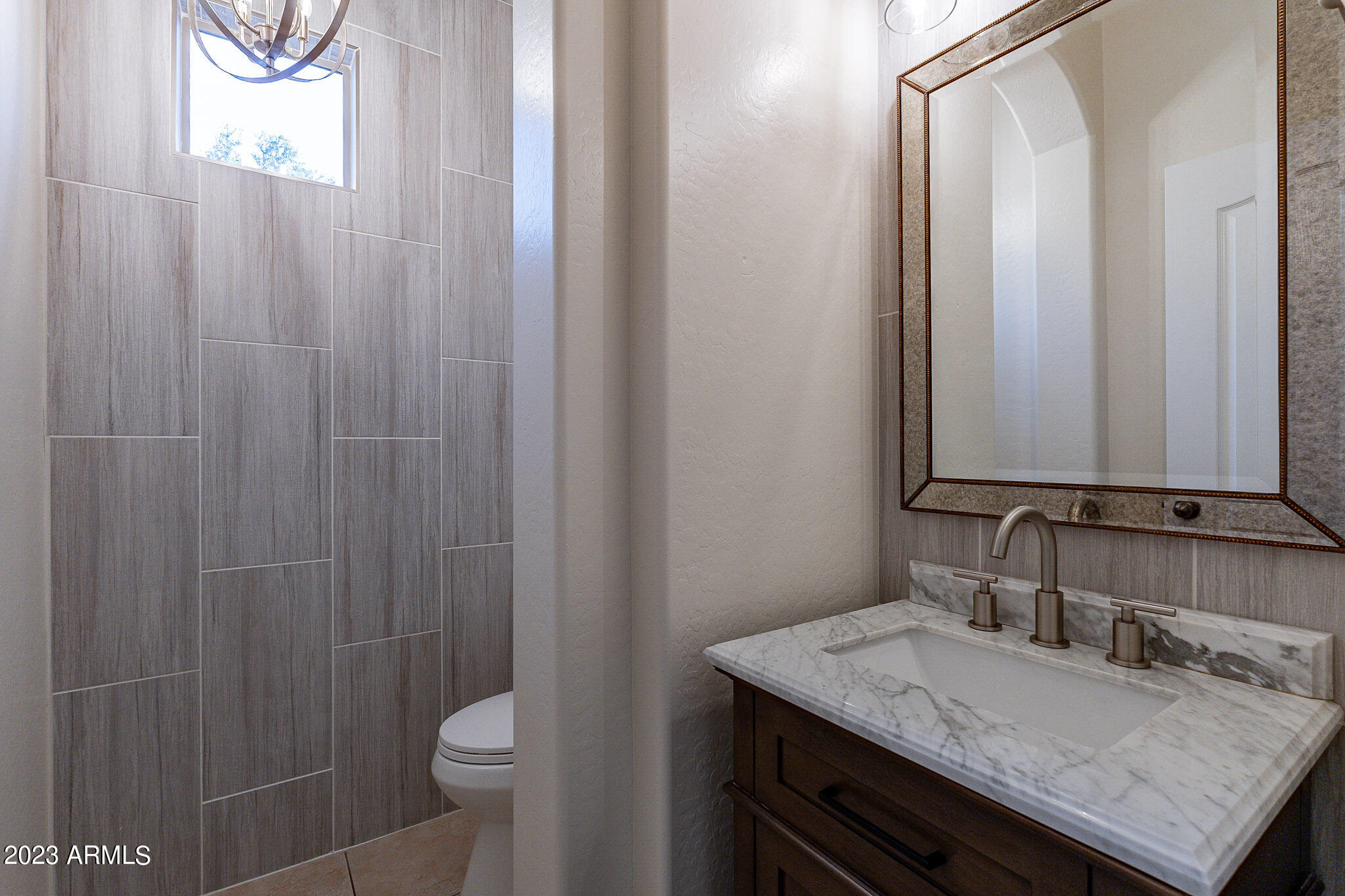 2943 East Quiet Hollow Lane Phoenix, AZ 85024 - Photo 28 of 65 a bathroom with a granite countertop sink and a toilet