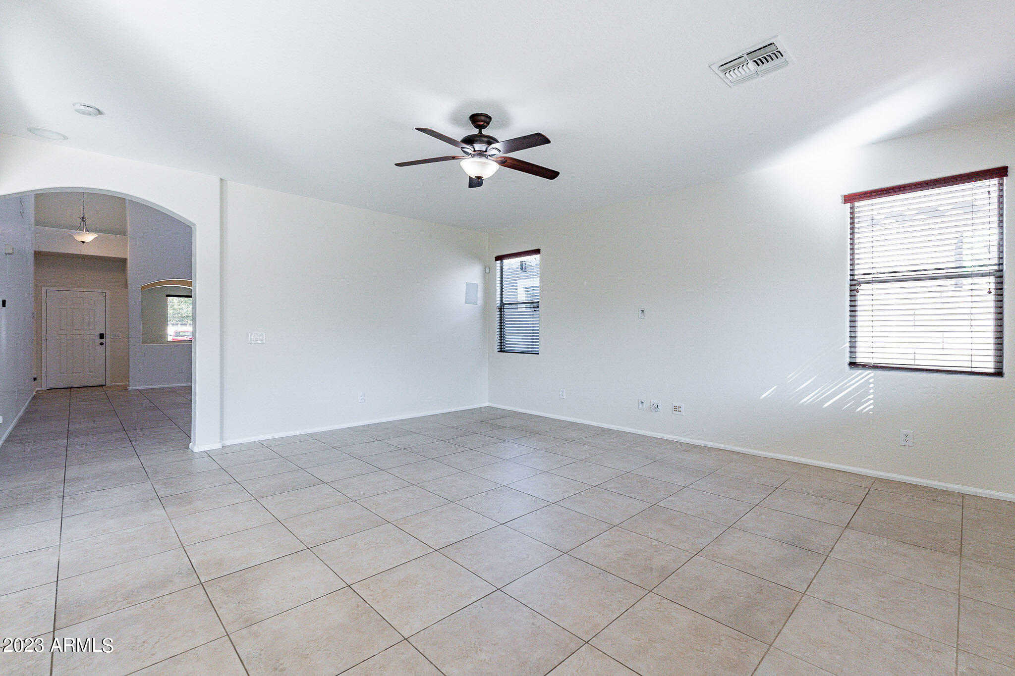 2943 East Quiet Hollow Lane Phoenix, AZ 85024 - Photo 30 of 65 an empty room with chandelier fan and windows