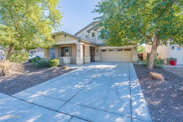 a front view of a house with a yard and a garage