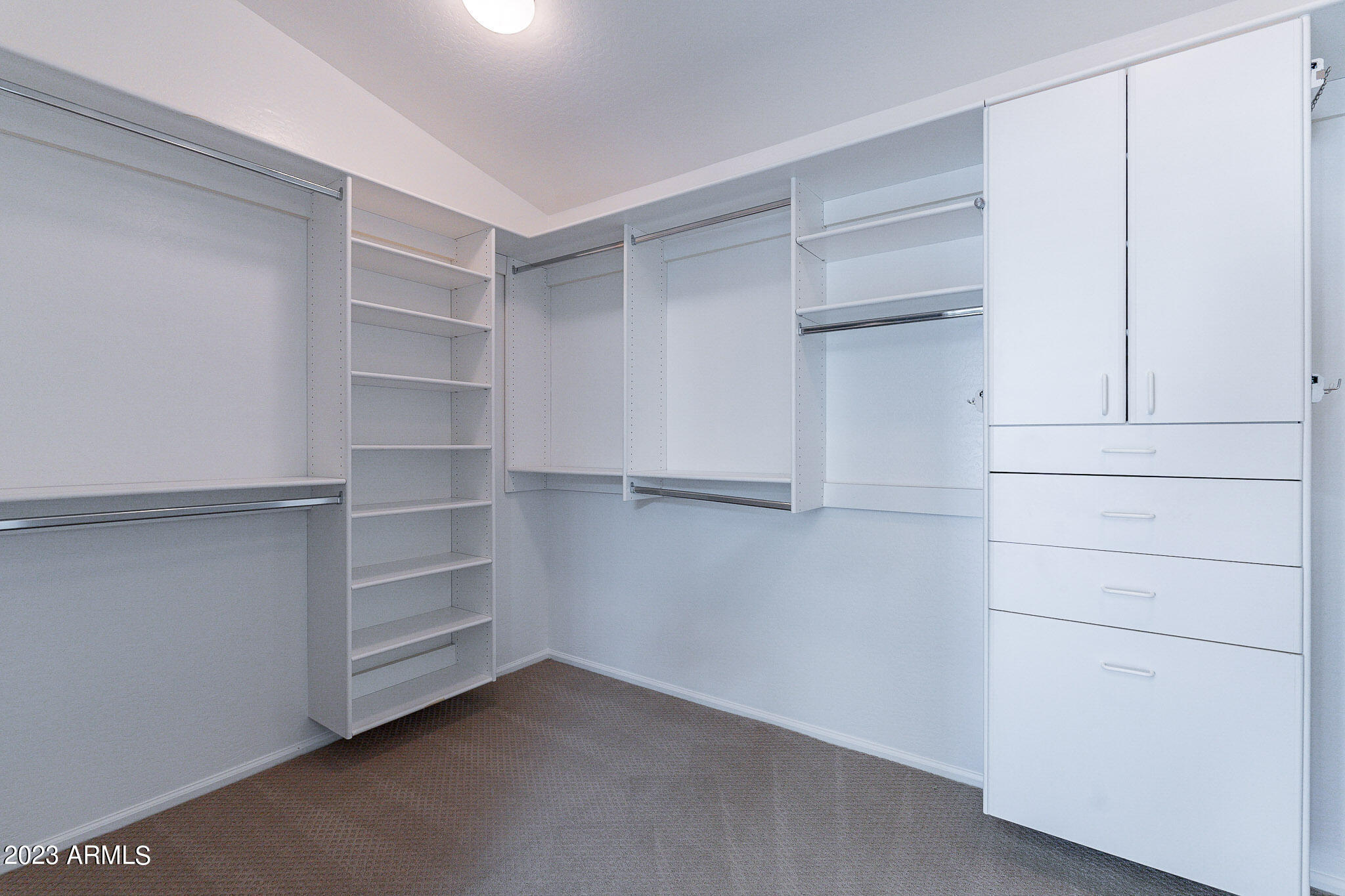 2943 East Quiet Hollow Lane Phoenix, AZ 85024 - Photo 47 of 65 a view of walk in closet with empty racks