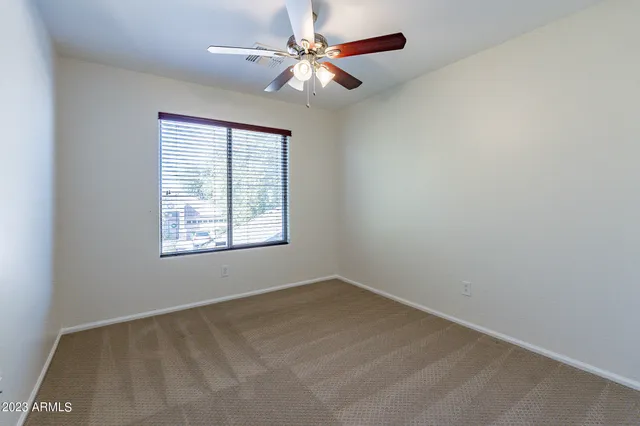 a view of house with a yard and large trees