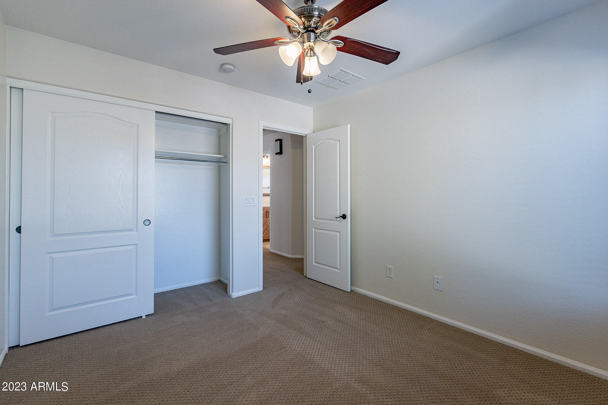 2943 East Quiet Hollow Lane Phoenix, AZ 85024 - Photo 49 of 65 an empty room with closet and a ceiling fan