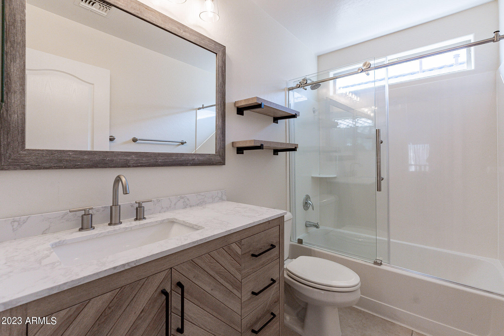 2943 East Quiet Hollow Lane Phoenix, AZ 85024 - Photo 52 of 65 a bathroom with a sink toilet and shower