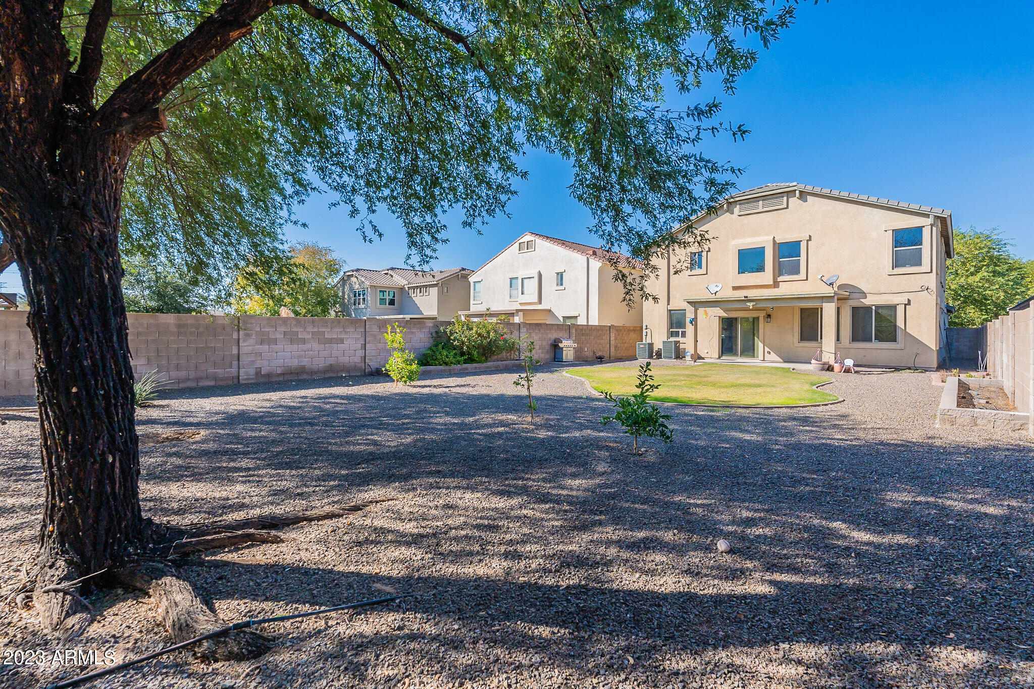 2943 East Quiet Hollow Lane Phoenix, AZ 85024 - Photo 63 of 65 a view of house with a yard and large trees