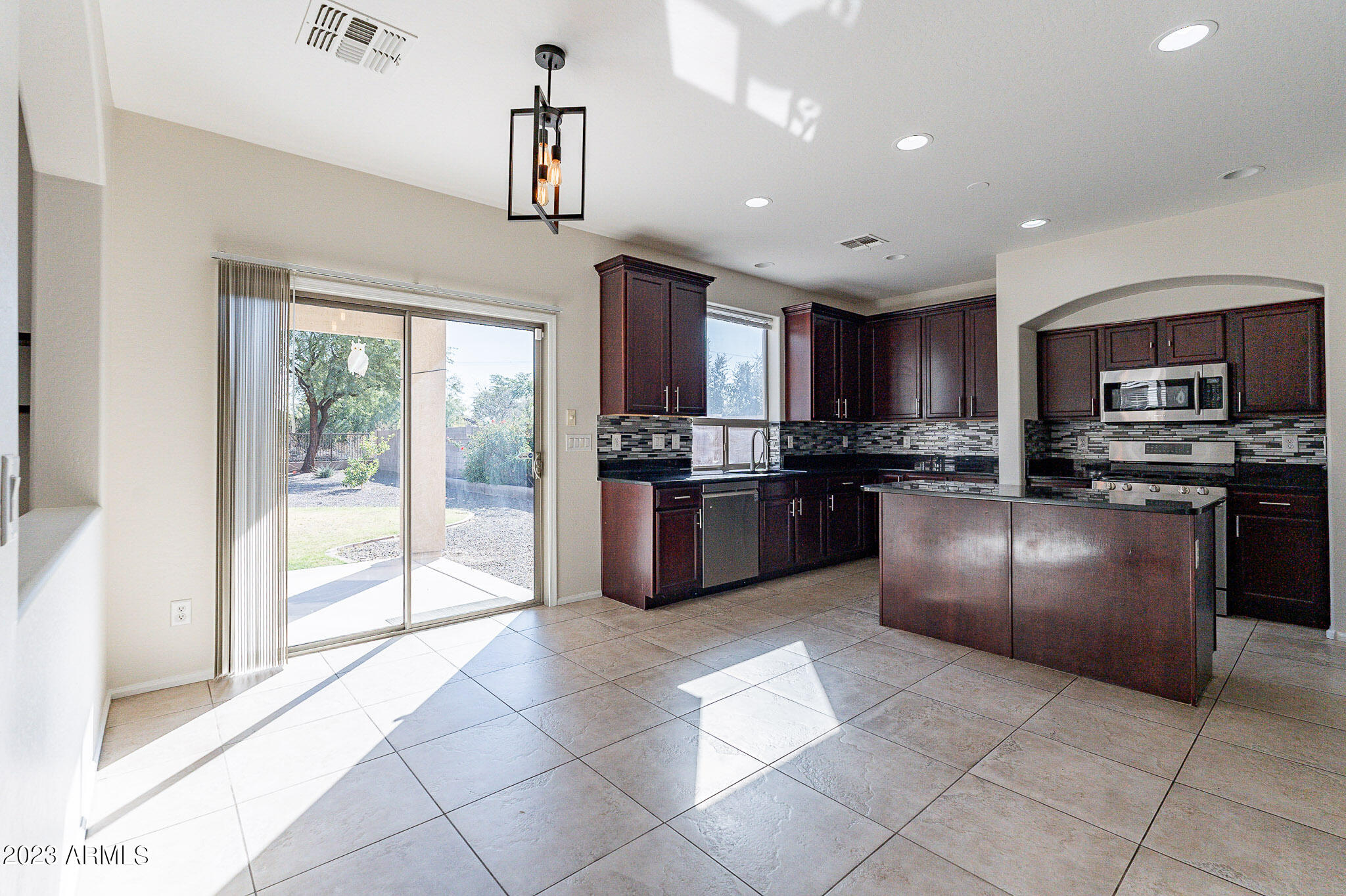 2943 East Quiet Hollow Lane Phoenix, AZ 85024 - Photo 10 of 65 a kitchen with granite countertop a refrigerator and a sink