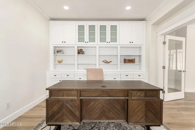 a kitchen with a sink cabinets and wooden floor